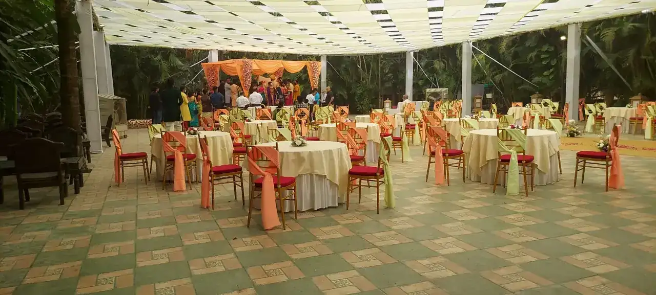 Banquet tables set under the white canopy at Exotica
